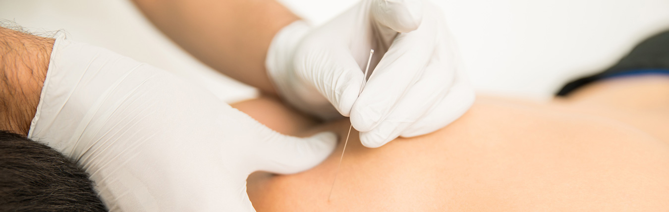 Close up needle near back of a person.