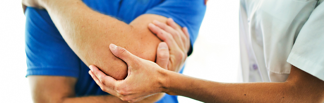 Close up of man holding elbow.